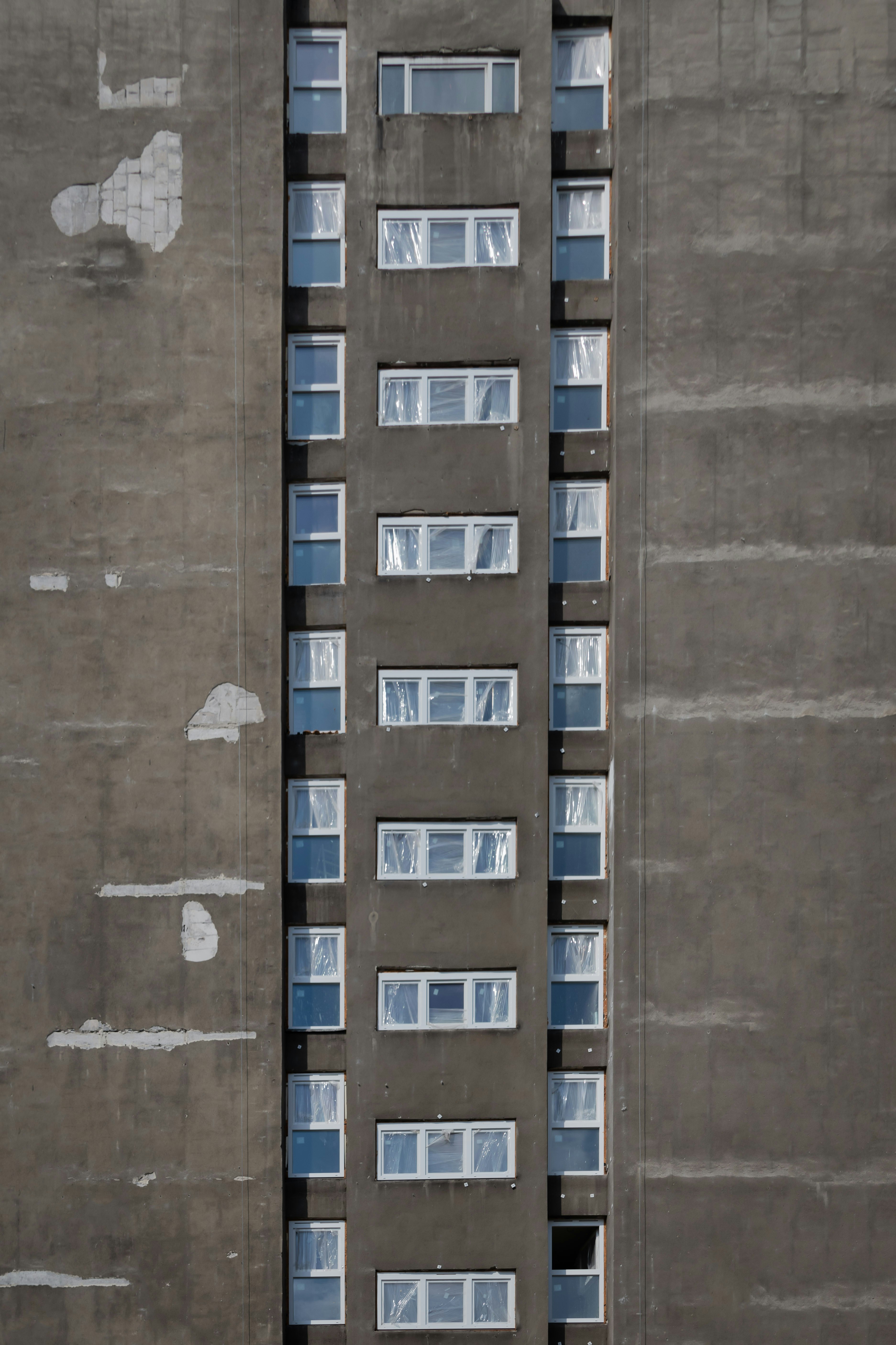 gray building sowing glass windows